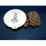 A cast iron weighing scales and weights with a white stoneware base and painted lady detail.