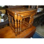 A nest of three mid Oak finished occasional Tables standing on turned legs,