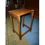 A rectangular Oak occasional Table standing on chamfered square legs,
