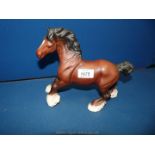 A Beswick Cantering shire horse in a brown matt finish, 10" long x 8 1/4" tall.