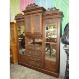 A most substantial Walnut and Mahogany breakfront Wardrobe with carved shell and scroll deail and