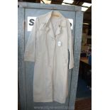 A 'Kirsten' long cream Raincoat, size 14.