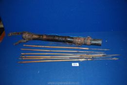 An old Leather Quiver and six bamboo arrows with hand forged barbed iron points, the longest 64 cm,