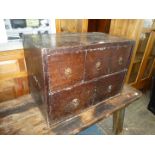 An uncommon Oak Campaign Chest having three small above two larger drawers with brass floriate back