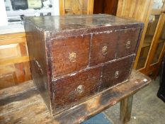 An uncommon Oak Campaign Chest having three small above two larger drawers with brass floriate back