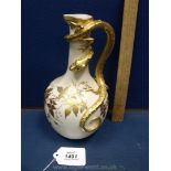 A Royal Worcester Ewer having a lizard handle in blush colour and gilt decoration,