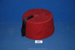 A Fez hat, wine colour.