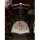 A pretty dark Mahogany framed Edwardian open armed Elbow Chair having cream ground floral and