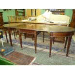 An elegant circa 1900 Mahogany 'D' end Dining Table standing on tapering square legs terminating