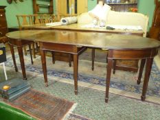 An elegant circa 1900 Mahogany 'D' end Dining Table standing on tapering square legs terminating