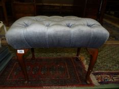 A dressing Stool in blue buttoned draylon upholstery.