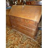 A 19th c, oak Bureau having sloping front revealing a fitted interior,