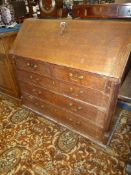 A 19th c, oak Bureau having sloping front revealing a fitted interior,