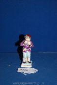 A fine small porcelain figure of a boy, representing the month of January,