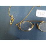 A yellow metal Pince-Nez and Chain, chip to lens.