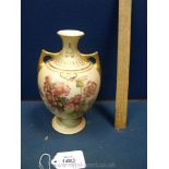 A Royal Worcester two handled Vase in blush ivory decorated with flowers back and front,