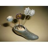 A plated Lady's shoe Pin Cushion and four various hat or tie pins