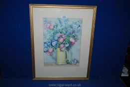 A framed and mounted Watercolour of a still life depicting a yellow tankard with flowers,