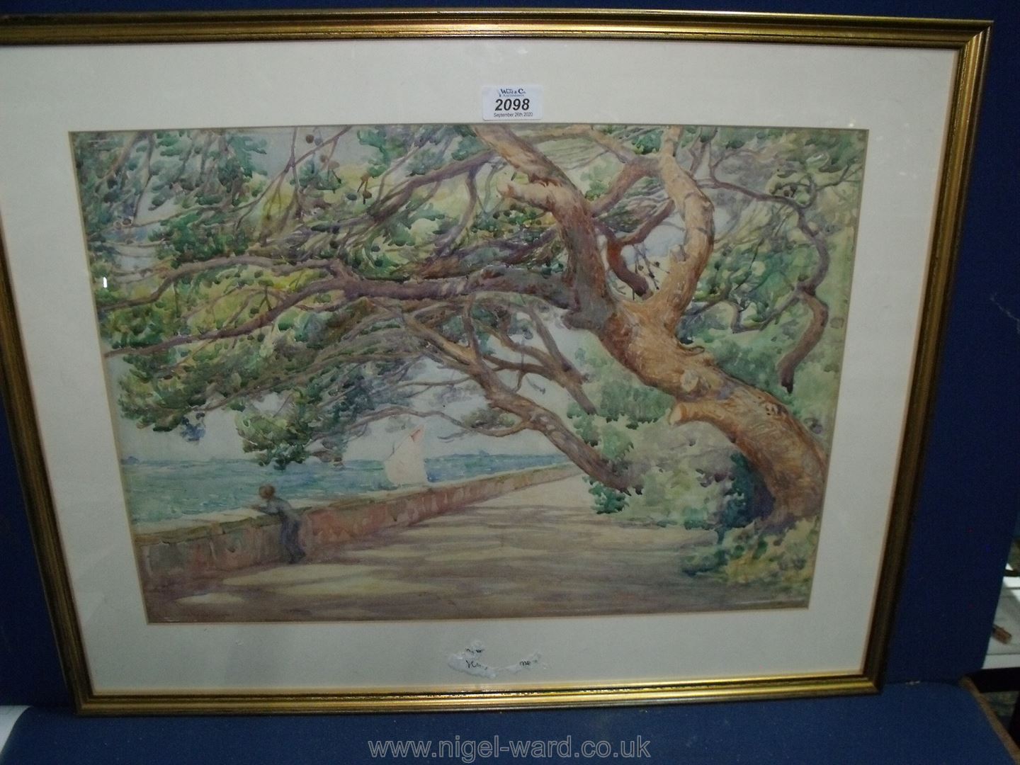A framed and mounted Watercolour of a figure by a coastal scene, signed lower left L.