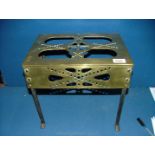 An antique pierced brass fireside cottage Footman/trivet on wrought iron legs, possibly Welsh.