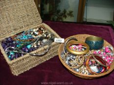 Two baskets of costume jewellery.