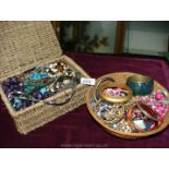 Two baskets of costume jewellery.