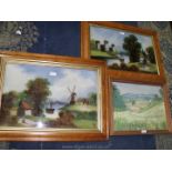 A pair of Maple framed Oil paintings depicting a castle on river bank with a figure by a cottage,