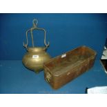 A copper flower Trough with lion head handles and a Brass cauldron style cooking Pot.