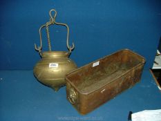A copper flower Trough with lion head handles and a Brass cauldron style cooking Pot.