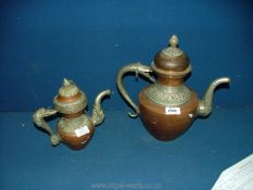 Two copper and white metal kettles one large the other small Nepalese religious version.