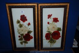 Two pictures with red and cream glass painted flowers.