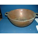 A large two handled round bottomed Copper Bowl, 8 1/2" high x 19" diameter.