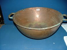 A large two handled round bottomed Copper Bowl, 8 1/2" high x 19" diameter.