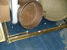 An adjustable brass fire kerb.