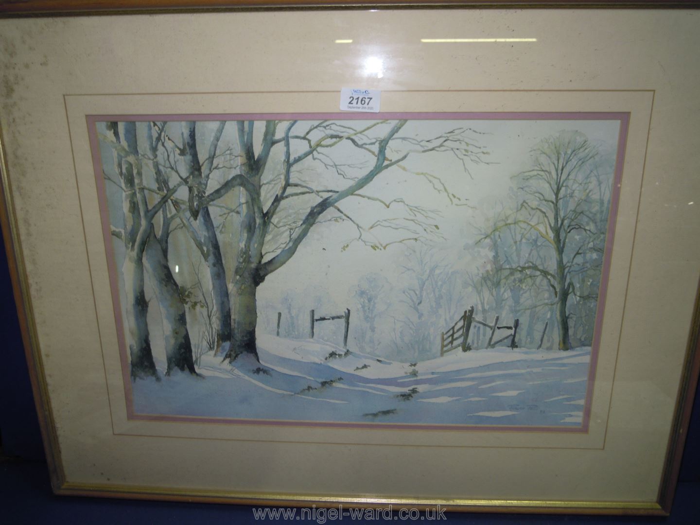 A large framed and mounted watercolour depicting a snowy country scene; signed Robert Price,