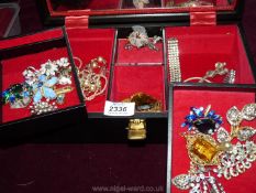 A black Musical Jewellery case with ballerina, containing miscellaneous costume jewellery, brooches,