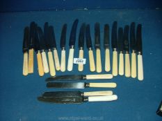 A quantity of Sheffield dinner knives and cheese knives, mostly bone handles.