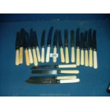 A quantity of Sheffield dinner knives and cheese knives, mostly bone handles.