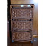 A wicker style three drawers storage unit.