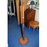 A turned wooden standard lamp column.