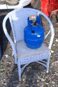 A Lloyd loom style chair and gas cylinder with contents