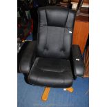 A black faux leather office chair.