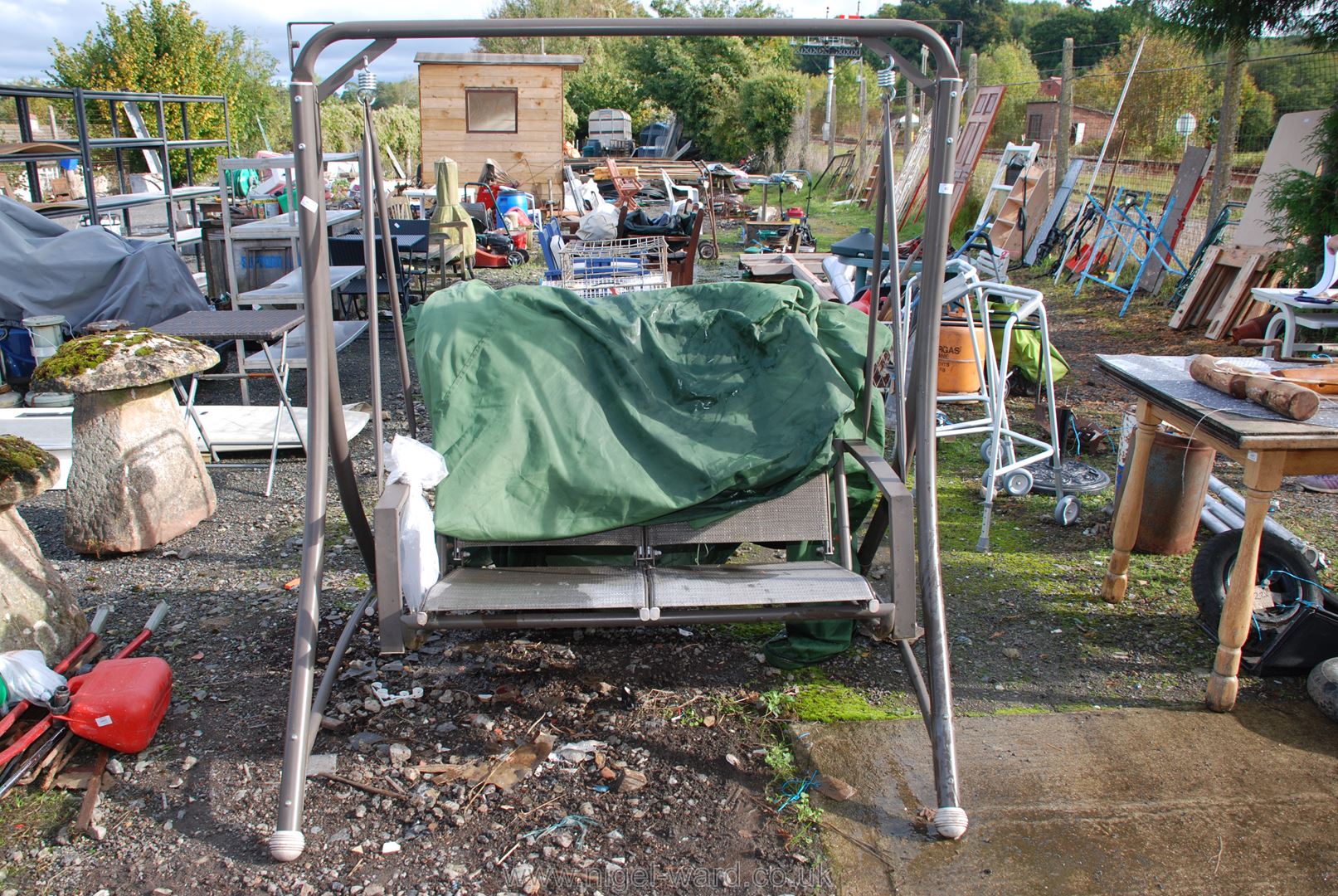 A two seater swing Garden seat with cover.