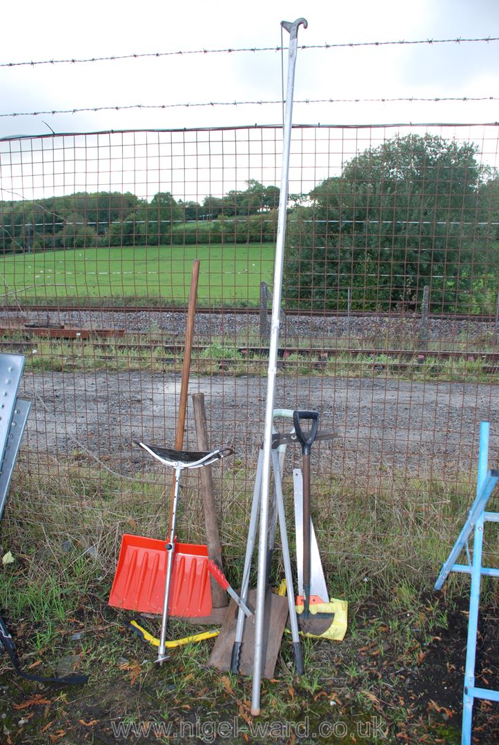 A shooting stick, snow shovel, tree prunes, pick shovel, etc.