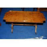 A coffee table with turned supports and brass claw casters. 40" long x 18" x 19 1/2" high.