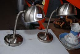 A pair of flexi arm table lamps.