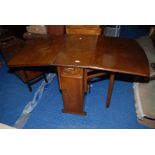 A drop leaf dining table with cupboards and drawers to central leg section. 60" x 32" x 30" high.