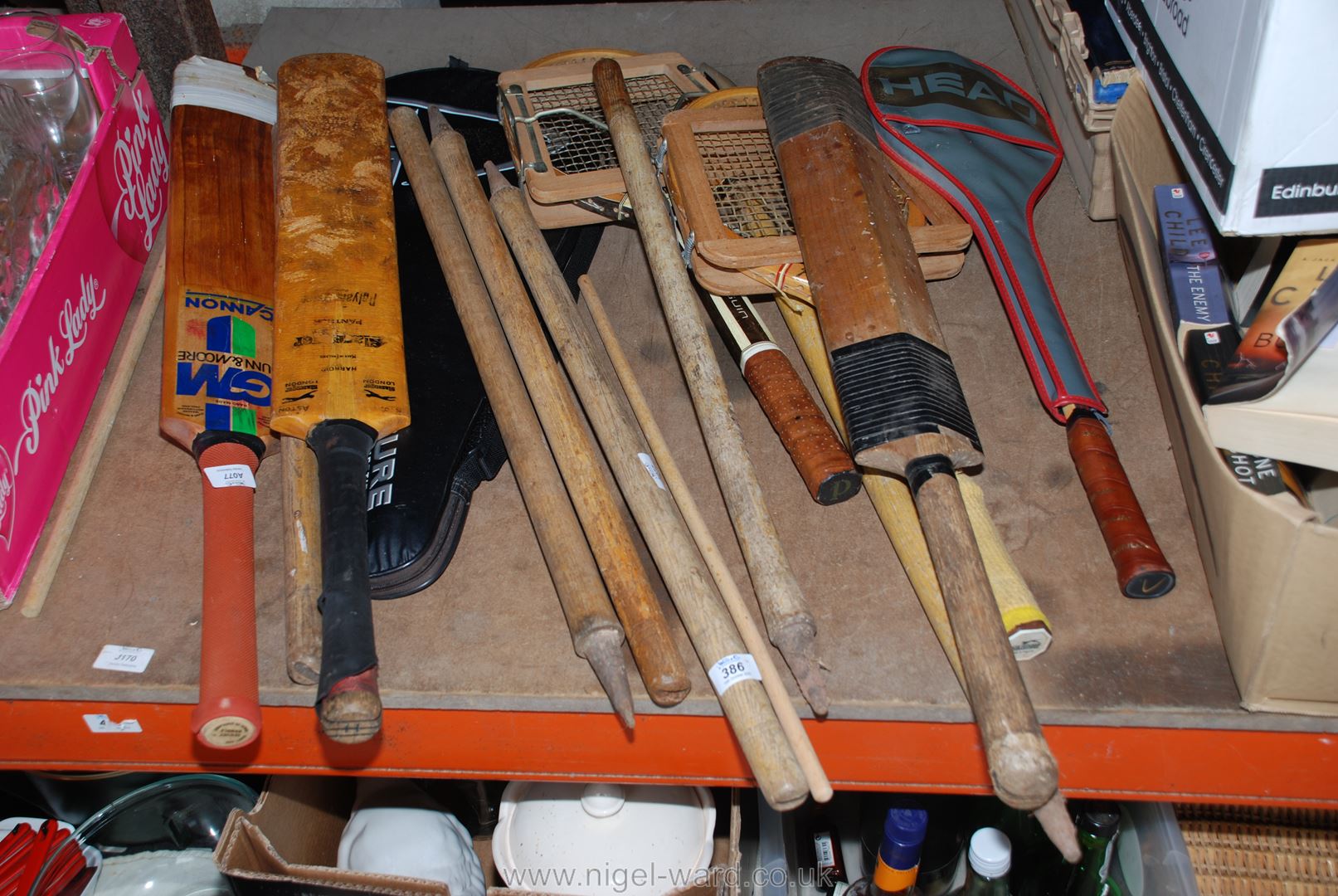 A quantity of tennis, squash and badminton rackets, cricket bats and stumps.