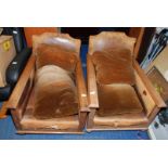 A pair of oak framed arm chairs A/F.