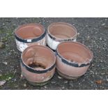 4 plastic barrel planters.